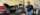 person stands beside a partially built tractor in an automotive shop
