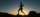 silhouette of man jumping on rocky mountain during sunset