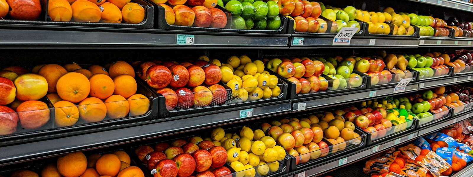 yellow and red apples on black plastic crate