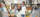 A person in a lab coat uses a multichannel pipette in a lab as another person watches and smiles