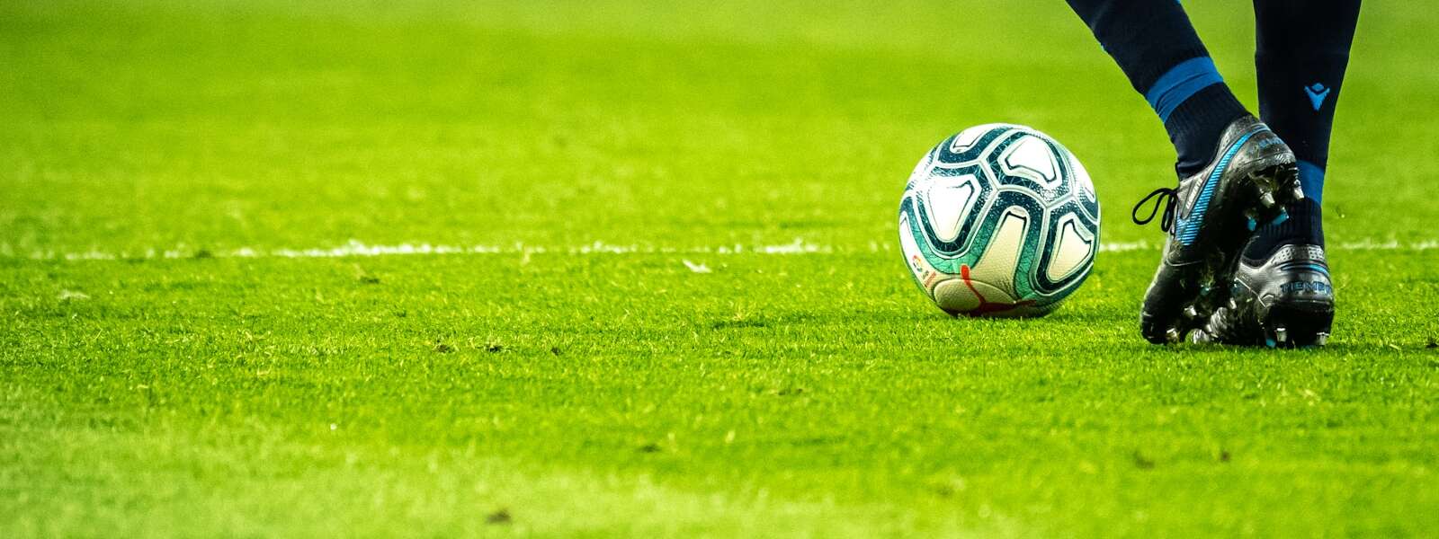 man playing soccer game on field