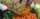person in white long sleeve shirt holding green cucumber