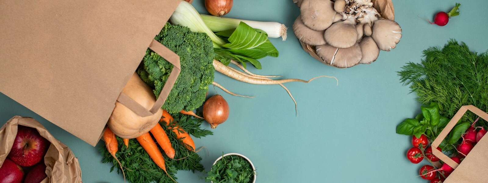 a table topped with bags filled with different types of vegetables