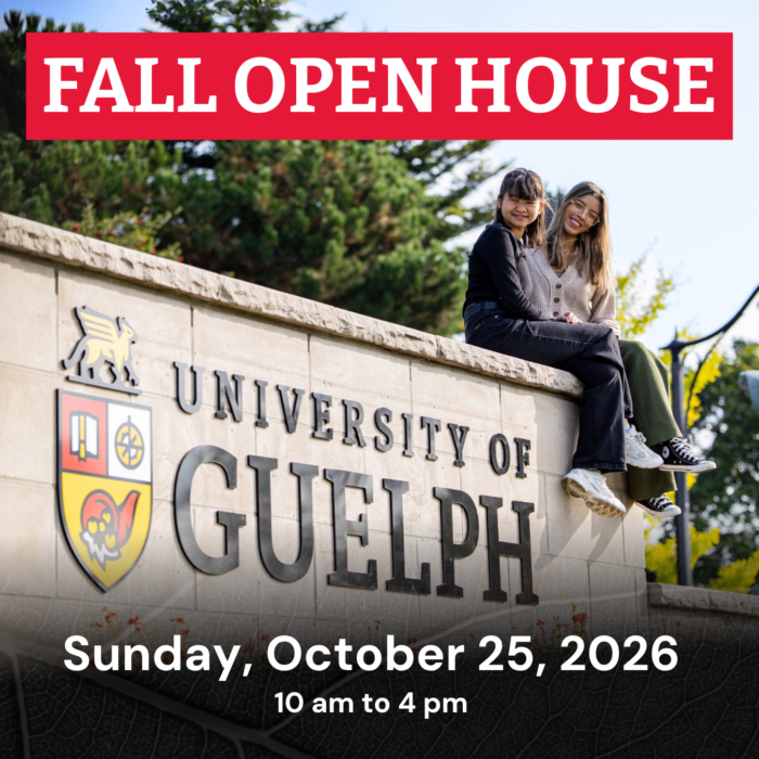 Fall open house. Students sit on the University of Guelph sign.